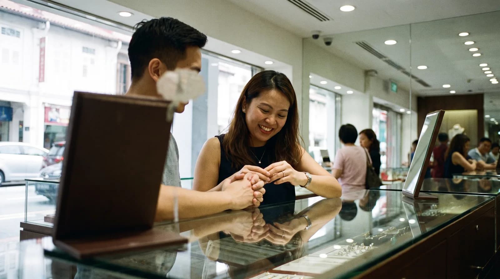 A couple trying on rings at a jewellery store