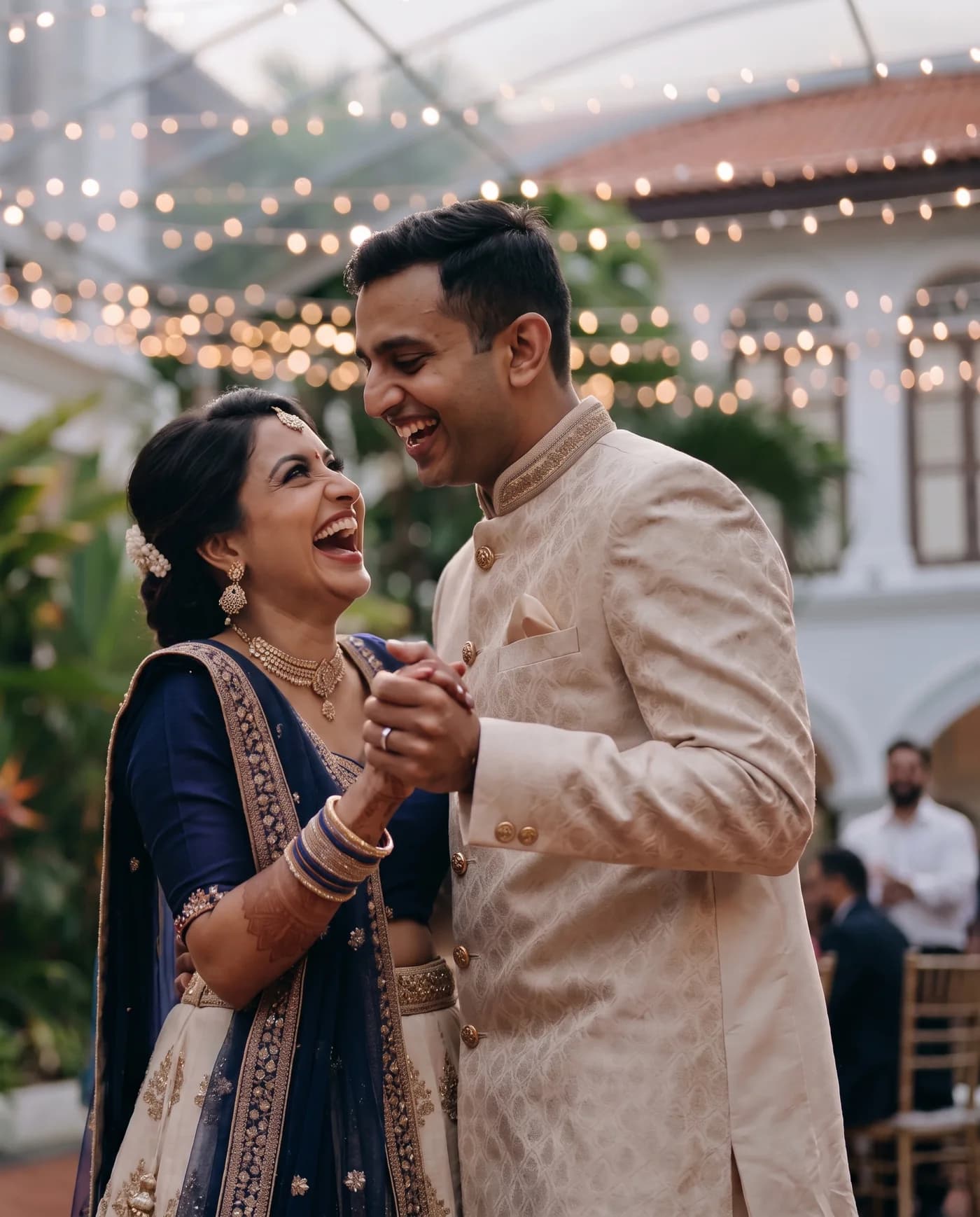 An Indian couple laughing together at their wedding celebration
