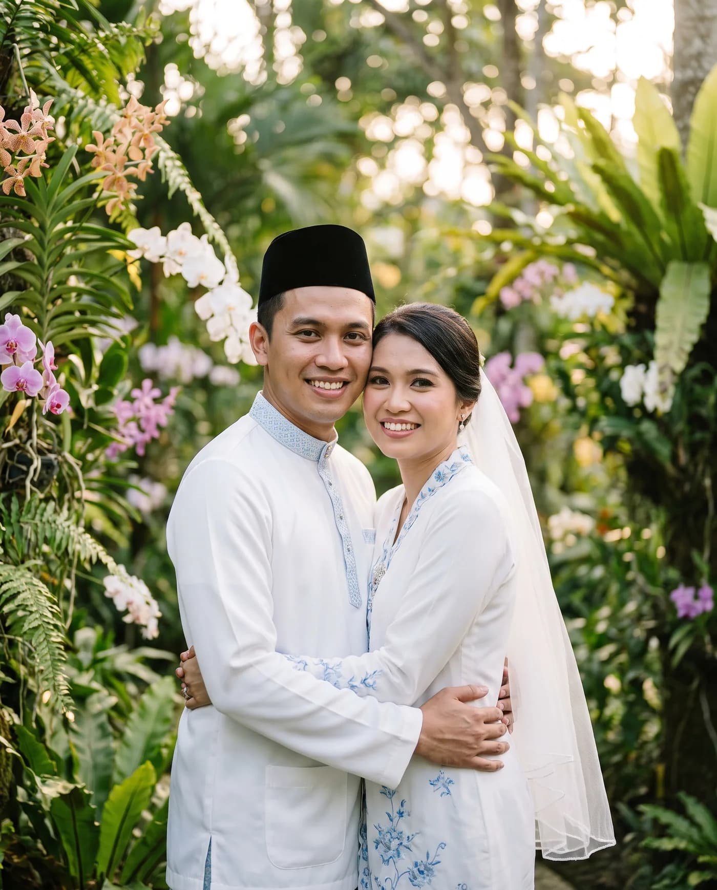 A Malay couple in traditional wedding attire in a garden